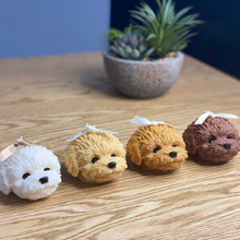 Load image into Gallery viewer, Little oodle dog head candles with ribbons on their heads, all lined up. Colours white, light tan, dark tan and brown.